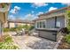 Inviting backyard patio features pavers, a hot tub, a seating area around a fire pit, and string lights above at 13864 Sachs Ave, Orlando, FL 32827