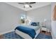 Bright bedroom with hardwood floors, a ceiling fan, and white nightstands on each side of the bed at 13864 Sachs Ave, Orlando, FL 32827