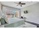 Bright bedroom featuring a large window, ceiling fan, and wall mounted TV at 13864 Sachs Ave, Orlando, FL 32827