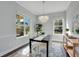 Bright dining room featuring a stylish chandelier and large windows at 13864 Sachs Ave, Orlando, FL 32827