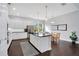 Elegant kitchen with white cabinets, black countertop and stainless steel appliances at 13864 Sachs Ave, Orlando, FL 32827