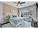 Comfortable main bedroom with a ceiling fan, large window and accent wall with decor at 13864 Sachs Ave, Orlando, FL 32827