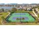 Aerial view featuring community tennis courts next to a scenic lake at 13864 Sachs Ave, Orlando, FL 32827