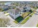 Aerial view of a modern home featuring a pool, manicured lawns, and a view of the nearby lake at 13875 Sachs Ave, Orlando, FL 32827