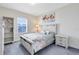 Bright bedroom with a floral-themed bedspread, a window, and a shelf at 13875 Sachs Ave, Orlando, FL 32827