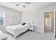 Well-lit bedroom with carpet, ceiling fan, and a view to the en-suite bathroom at 13875 Sachs Ave, Orlando, FL 32827