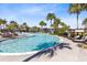 Serene community pool boasts lush tropical landscaping, lounge chairs and shallow wading areas at 13875 Sachs Ave, Orlando, FL 32827