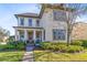 Charming two-story home featuring well-maintained landscaping, a front porch and neutral tones at 13875 Sachs Ave, Orlando, FL 32827