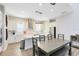 Bright kitchen and dining area with white cabinets, stainless appliances, and modern pendant lights at 13875 Sachs Ave, Orlando, FL 32827