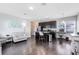 Bright living room and kitchen featuring dark wood floors, a large island, and lots of natural light at 13875 Sachs Ave, Orlando, FL 32827