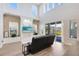 Bright living room featuring a stone accent wall, built-ins, and sliding glass doors at 13875 Sachs Ave, Orlando, FL 32827