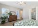 Comfortable bedroom featuring a dresser with mirror and access to the ensuite bathroom at 13875 Sachs Ave, Orlando, FL 32827