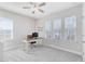 Bright office space with a modern desk, chair, ceiling fan, and multiple windows for natural light at 13875 Sachs Ave, Orlando, FL 32827