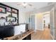 Bright home office with built-in shelves and desk, leading to an open kitchen space at 13875 Sachs Ave, Orlando, FL 32827