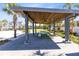 Community outdoor pavilion with wooden ceiling, picnic tables and lush landscaping at 13875 Sachs Ave, Orlando, FL 32827