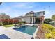 Backyard pool area featuring clear blue water, patio space, and lush landscaping at 13875 Sachs Ave, Orlando, FL 32827