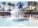 Fun splash pad features overhead water bucket, lounge chairs and mature palm trees at 13875 Sachs Ave, Orlando, FL 32827