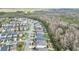 High-definition aerial shot of a neighborhood, featuring well-kept lawns and homes bordering a serene wooded area at 14150 Aldford Dr, Winter Garden, FL 34787