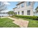 Backyard view highlighting brick pathway, lawn and the home's exterior at 14150 Aldford Dr, Winter Garden, FL 34787