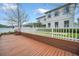 Expansive wood backyard deck enclosed with white picket fencing, steps, and outdoor living space at 14150 Aldford Dr, Winter Garden, FL 34787