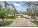 Expansive backyard with brick pathway, white picket fence, and well-manicured lawn at 14150 Aldford Dr, Winter Garden, FL 34787