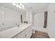 Bright bathroom featuring a wide mirror, quartz countertop, white cabinets, and a tub-shower combo at 14150 Aldford Dr, Winter Garden, FL 34787