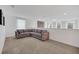 Bright bonus room with large gray sectional, neutral carpet, and natural light at 14150 Aldford Dr, Winter Garden, FL 34787