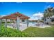 Community pool featuring a pergola with lounge chairs, tables, and a relaxing atmosphere at 14150 Aldford Dr, Winter Garden, FL 34787