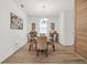 Elegant dining room with stylish chandelier, decorative art, and wood-look tile floors at 14150 Aldford Dr, Winter Garden, FL 34787