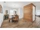 Elegant dining room with stylish wood accent wall, chandelier and tile floors at 14150 Aldford Dr, Winter Garden, FL 34787