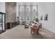 Spacious living room featuring a stone accent wall, high ceilings, and large windows at 14150 Aldford Dr, Winter Garden, FL 34787