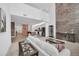 Open living space featuring a stone accent wall, white sofa, and an adjacent kitchen area at 14150 Aldford Dr, Winter Garden, FL 34787