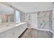 Bright bathroom with marble wall accent, double vanity, and tile flooring at 14150 Aldford Dr, Winter Garden, FL 34787