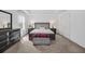 Main bedroom featuring tray ceiling, modern furnishings, neutral carpet, and lots of light at 14150 Aldford Dr, Winter Garden, FL 34787