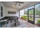 Relaxing screened-in patio with wicker furniture, a ceiling fan, and a view of the landscaped backyard at 14150 Aldford Dr, Winter Garden, FL 34787