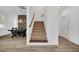 Entryway stairway with neutral carpet, wooden railing, wood-look floors and adjacent dining area at 14150 Aldford Dr, Winter Garden, FL 34787