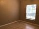 Clean, neutral bedroom with tile floor and window offering natural light at 145 Reserve Cir # 113, Oviedo, FL 32765