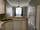 Kitchen featuring white cabinets and appliances, with a view into the dining area at 145 Reserve Cir # 113, Oviedo, FL 32765