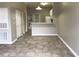 View of the living room, showing tile flooring and access to the kitchen and exterior at 145 Reserve Cir # 113, Oviedo, FL 32765