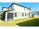 The back of this home features a covered porch, a freshly cut lawn, and plenty of space for outdoor living at 1522 Bantam Way, Winter Park, FL 32792