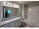 Well-lit bathroom with granite countertops and a large vanity mirror at 1522 Bantam Way, Winter Park, FL 32792