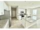 Bright and modern kitchen featuring an island, granite countertops, stainless steel appliances, and white cabinetry at 1522 Bantam Way, Winter Park, FL 32792