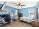 Vibrant bedroom with a ceiling fan and a large window providing natural light at 1700 Leatherback Ln, St Cloud, FL 34771