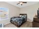 Comfortable bedroom with a ceiling fan and natural light from the window at 1700 Leatherback Ln, St Cloud, FL 34771