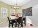 Cozy dining area with a modern light fixture and decorative wall art at 1700 Leatherback Ln, St Cloud, FL 34771