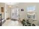 Bright foyer featuring tile flooring, a decorative glass door, and a staircase at 1700 Leatherback Ln, St Cloud, FL 34771