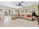 Spacious living room featuring neutral paint, tile floors, and sliding glass doors to an outdoor living area at 1700 Leatherback Ln, St Cloud, FL 34771