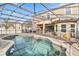 Inviting pool with spa, enclosed in a screened lanai perfect for outdoor relaxation at 1700 Leatherback Ln, St Cloud, FL 34771