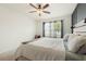 Bright bedroom features a ceiling fan, a window with natural light, and a stylish modern headboard at 1775 Copinger Ter, Kissimmee, FL 34744