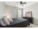 Well lit bedroom showcases natural light, a ceiling fan, and a large dresser with mirror at 1775 Copinger Ter, Kissimmee, FL 34744